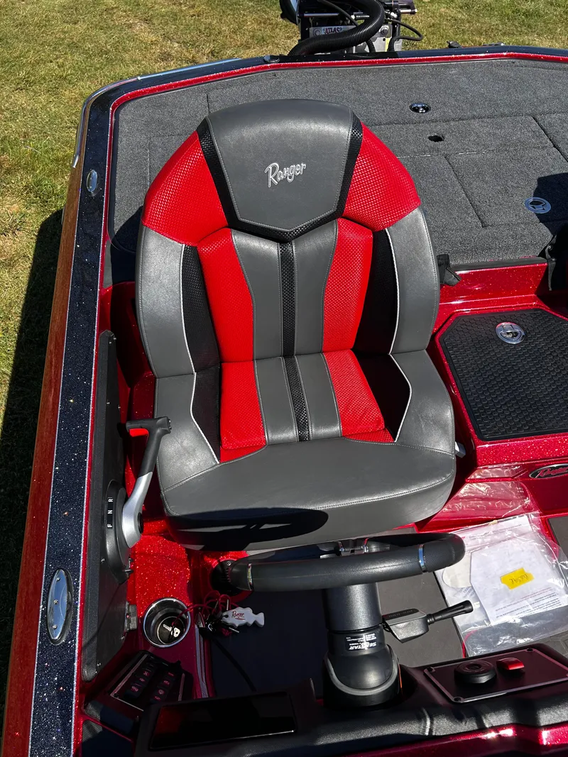 Slide: The Image of 2024 Ranger Z519 boat seat with red and black design, steering wheel visible. - 3