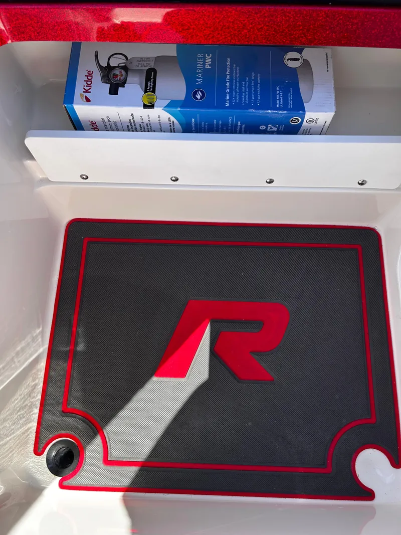 Slide: The Image of 2024 Ranger Z519 storage compartment with mat and Kidde Mariner fire extinguisher. - 31