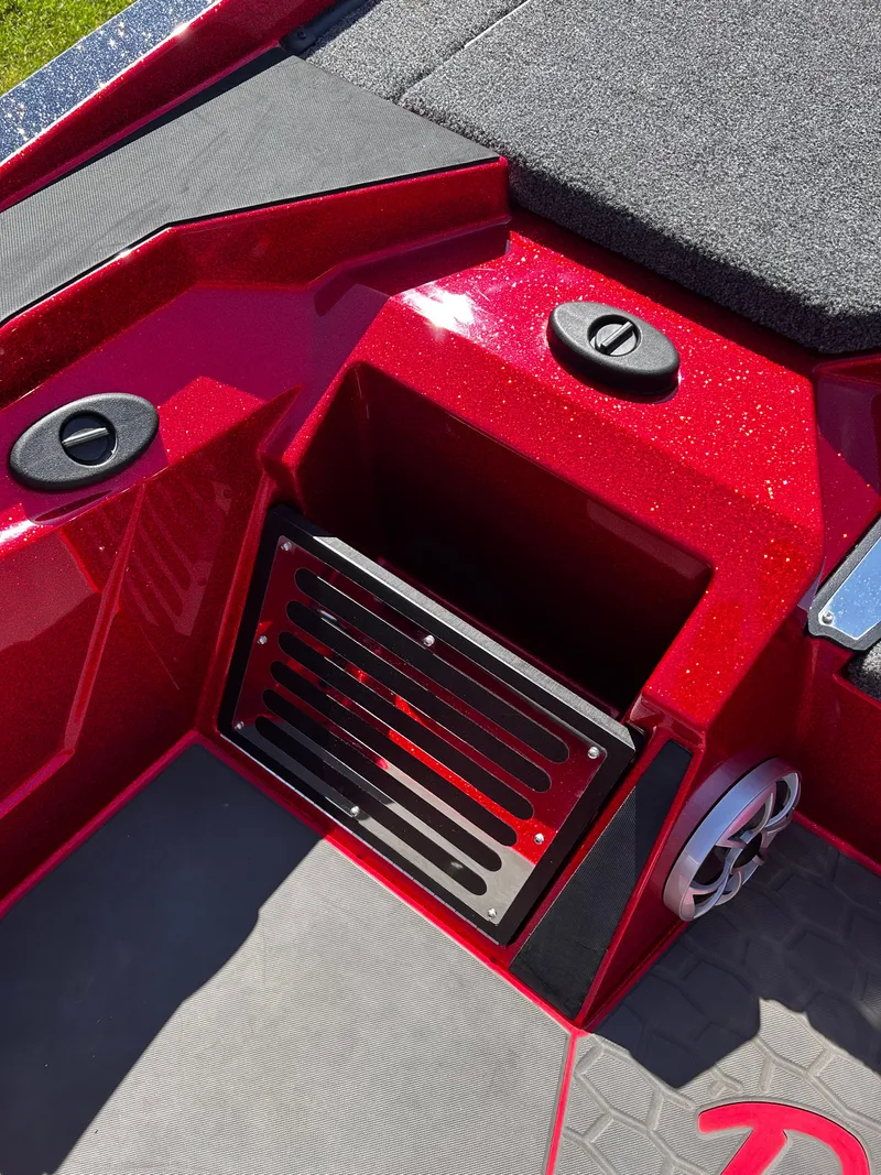 Slide: The Image of 2024 Ranger Z519 boat interior with red metallic finish and storage compartment. - 33