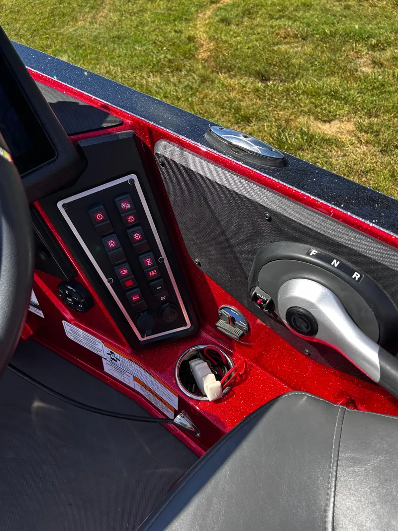 Slide: The Image of 2024 Ranger Z519 boat control panel with switches and throttle lever. - 4
