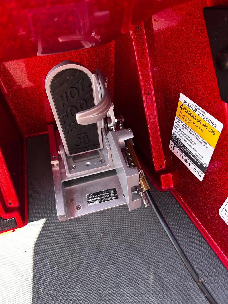 Slide: The Image of 2024 Ranger Z519 boat foot pedal and capacity label in red interior. - 5