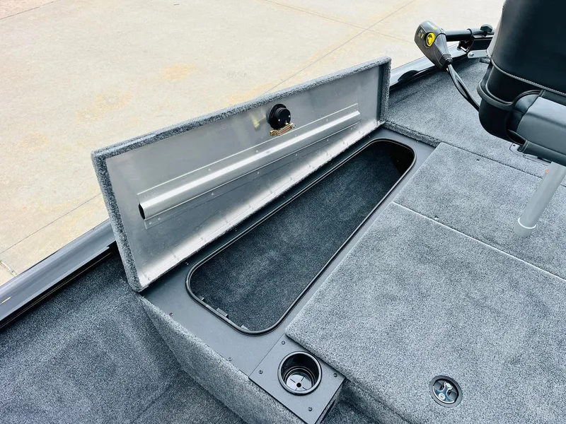 Slide: The Image of 2026 Tracker Pro Team 175 boat interior with open storage compartment and carpeted flooring. - 11