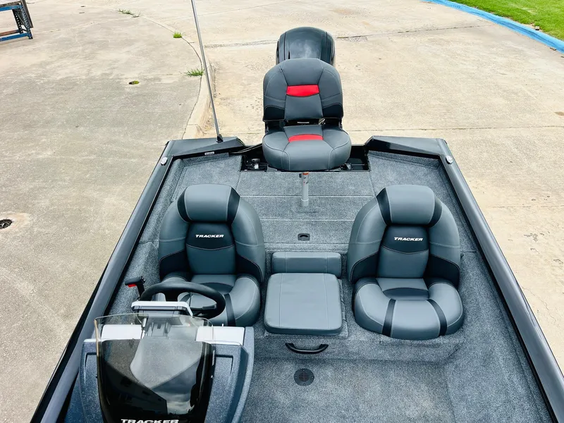 Slide: The Image of 2026 Tracker Pro Team 175 boat interior with gray seating and steering console. - 20