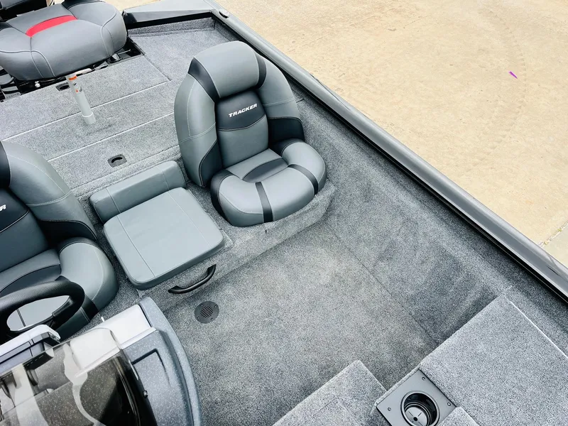 Slide: The Image of 2026 Tracker Pro Team 175 boat interior with gray seating and carpeted flooring. - 21