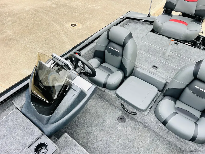 Slide: The Image of 2026 Tracker Pro Team 175 boat interior with gray seating and steering console. - 22