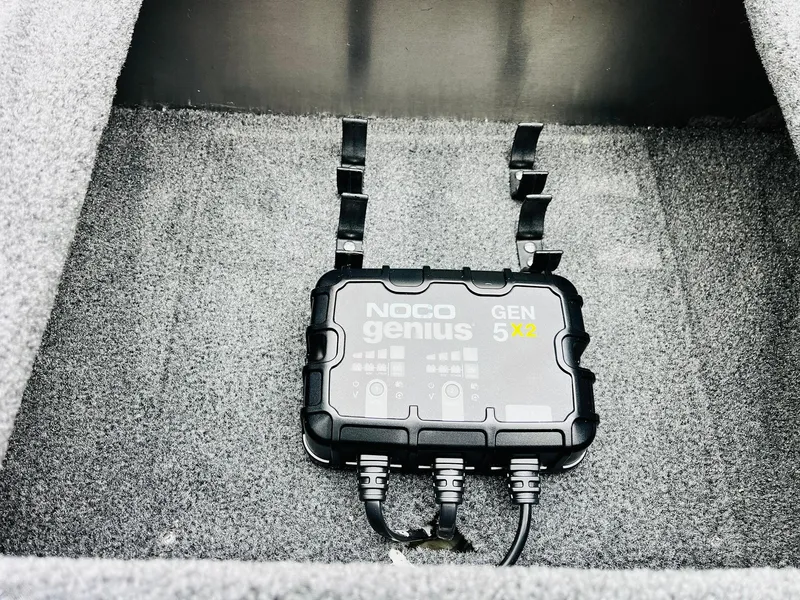 Slide: The Image of NOCO Genius GEN5X2 charger in 2026 Tracker Pro Team 175 boat compartment. - 24