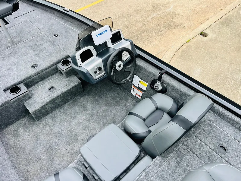 Slide: The Image of 2026 Tracker Pro Team 175 boat interior with steering console and seating. - 25