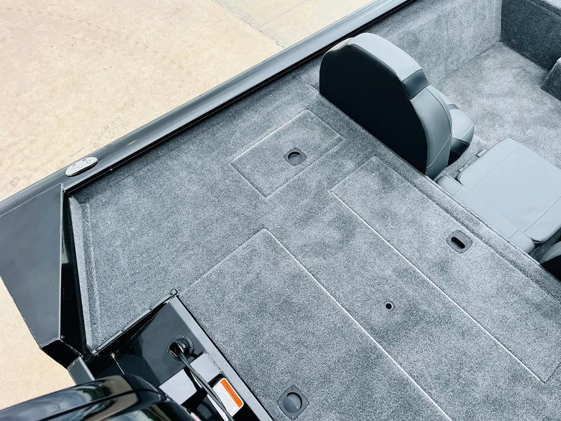 Slide: The Image of Interior of 2026 Tracker Pro Team 175 boat with gray carpet and seating. - 32