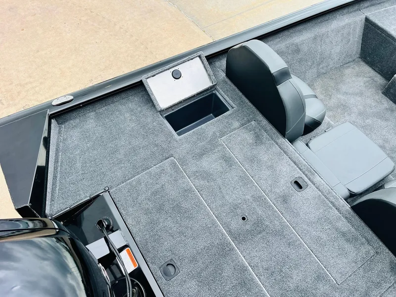 Slide: The Image of 2026 Tracker Pro Team 175 boat interior with gray carpet and seating. - 33