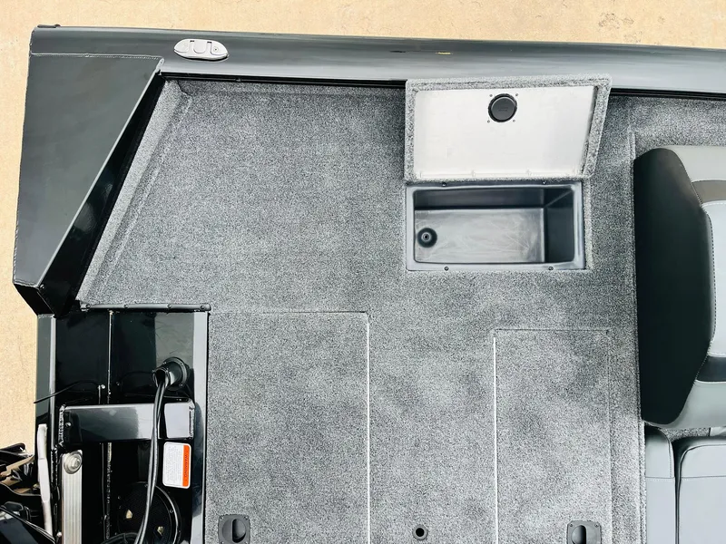 Slide: The Image of 2026 Tracker Pro Team 175 boat interior with storage compartment and carpeted flooring. - 34