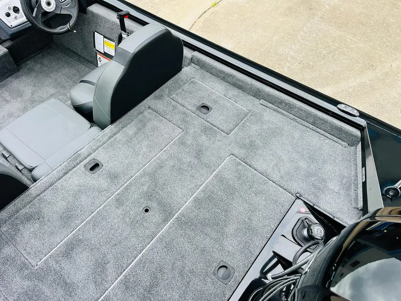 Slide: The Image of 2026 Tracker Pro Team 175 boat interior with gray carpet and seating. - 35