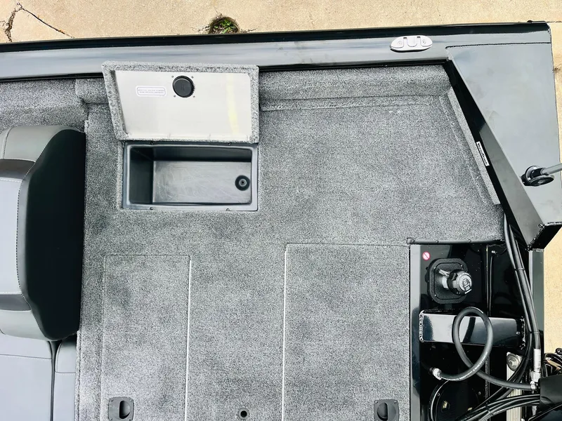 Slide: The Image of 2026 Tracker Pro Team 175 boat interior with storage compartment and control panel. - 37