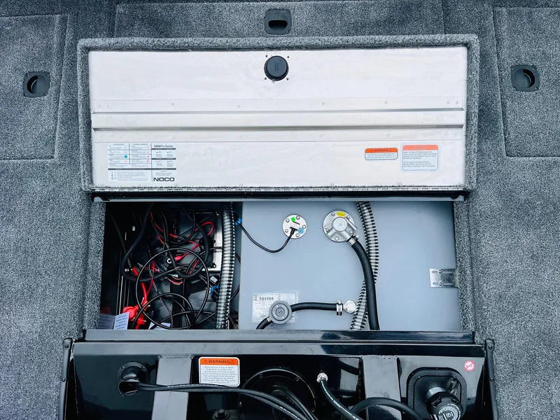 Slide: The Image of Tracker Pro Team 175 2026 boat battery compartment with wiring and controls. - 38