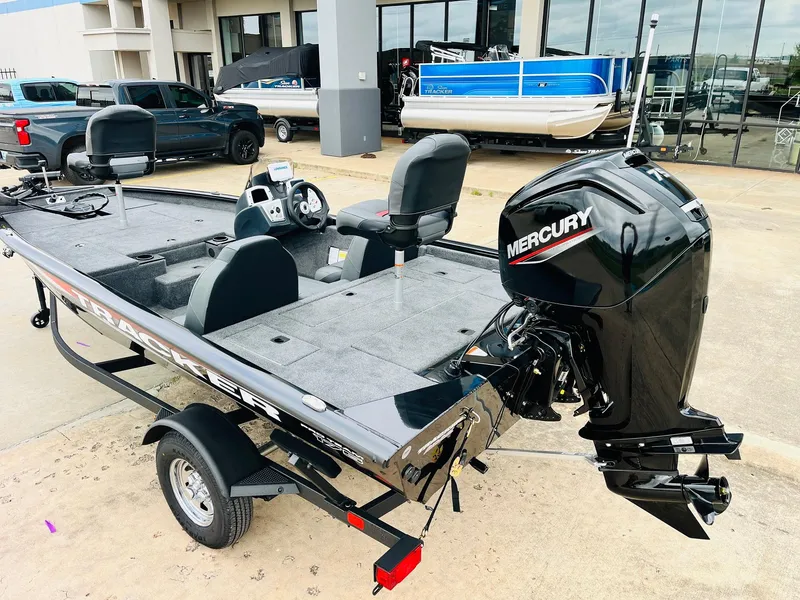 Slide: The Image of 2026 Tracker Pro Team 175 boat with Mercury engine, parked outdoors. - 5