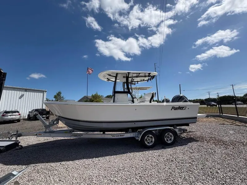 The Image of 2025 Parker 23SE Center Console boat on trailer under blue sky. - 0