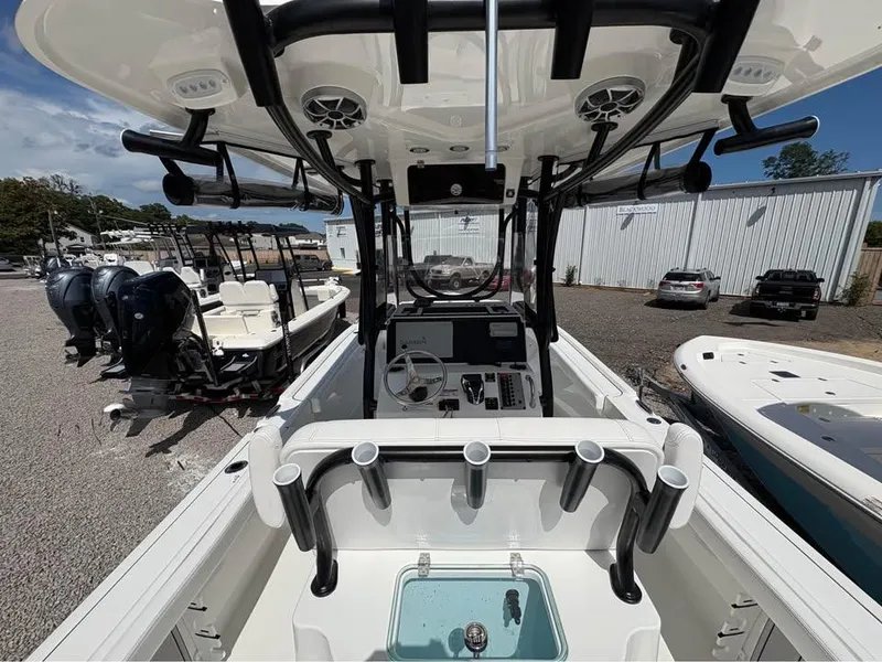 Slide: The Image of 2025 Parker 23SE Center Console boat interior with steering wheel and rod holders. - 12