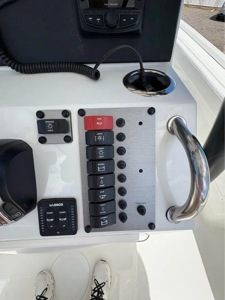 Slide: The Image of Control panel of a 2025 Parker 23SE Center Console boat with switches and controls. - 13