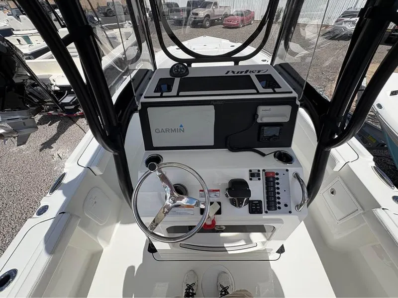 Slide: The Image of 2025 Parker 23SE Center Console boat with Garmin navigation system and steering wheel. - 14
