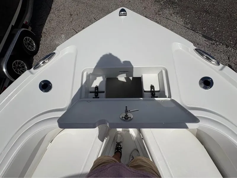 Slide: The Image of 2025 Parker 23SE Center Console boat deck with storage compartment open. - 19