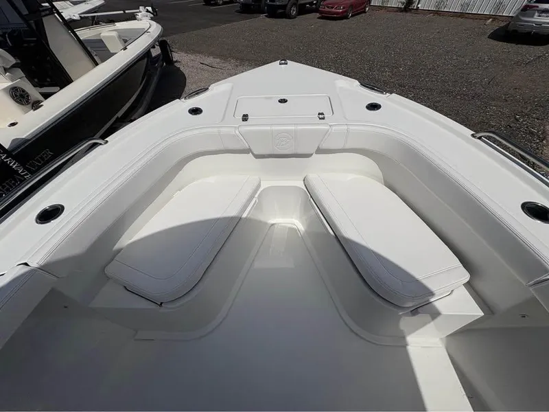 Slide: The Image of 2025 Parker 23SE Center Console boat with white seating and spacious deck. - 20