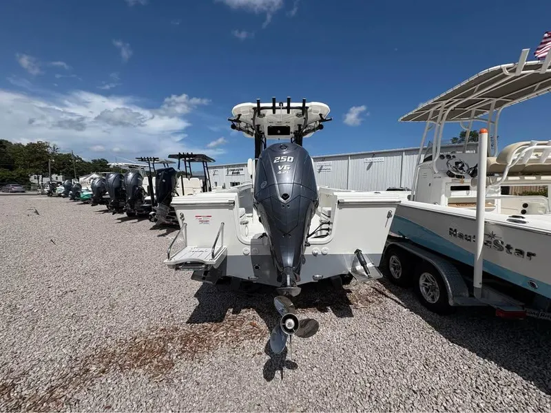 Slide: The Image of 2025 Parker 23SE Center Console boat with 250 V6 engine, displayed outdoors. - 3