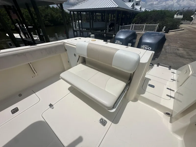 Slide: The Image of 2009 Pursuit C 310 Center Console boat with foldable seating and dual Yamaha engines. - 12