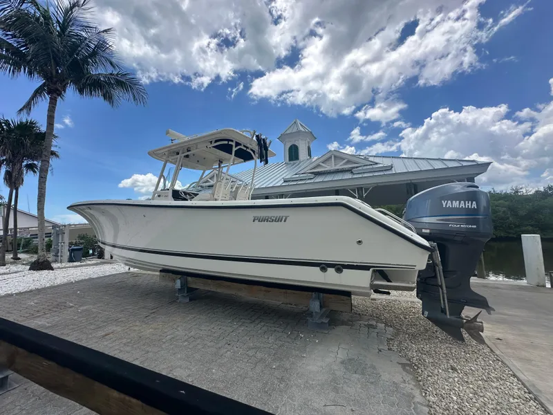 Slide: The Image of 2009 Pursuit C 310 Center Console boat on display with Yamaha engine. - 2