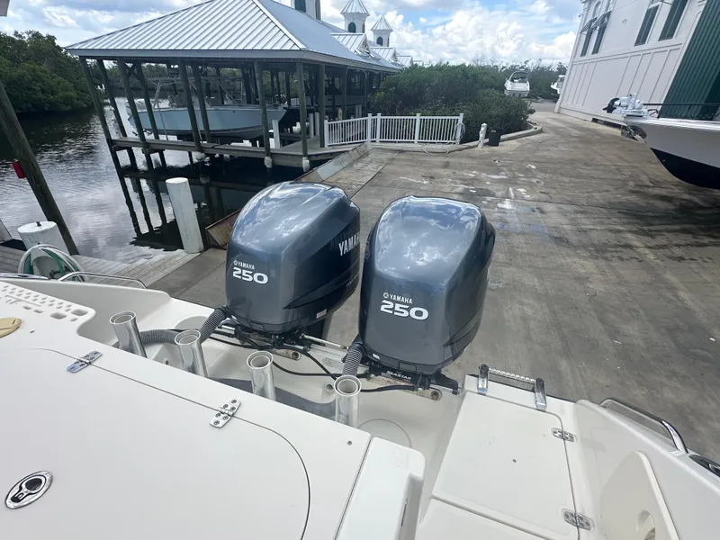 Slide: The Image of 2009 Pursuit C 310 Center Console with twin Yamaha 250 engines at a marina dock. - 6