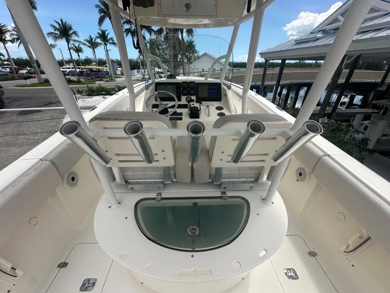 Slide: The Image of 2009 Pursuit C 310 Center Console boat interior with rod holders and steering console. - 8