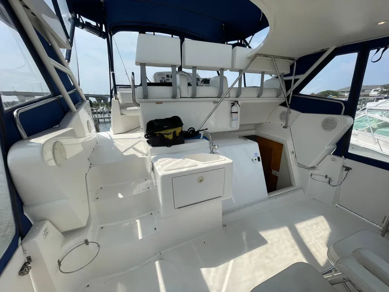 Slide: The Image of 1998 Silverton 322 Motor Yacht interior with seating, sink, and storage, featuring blue accents. - 6