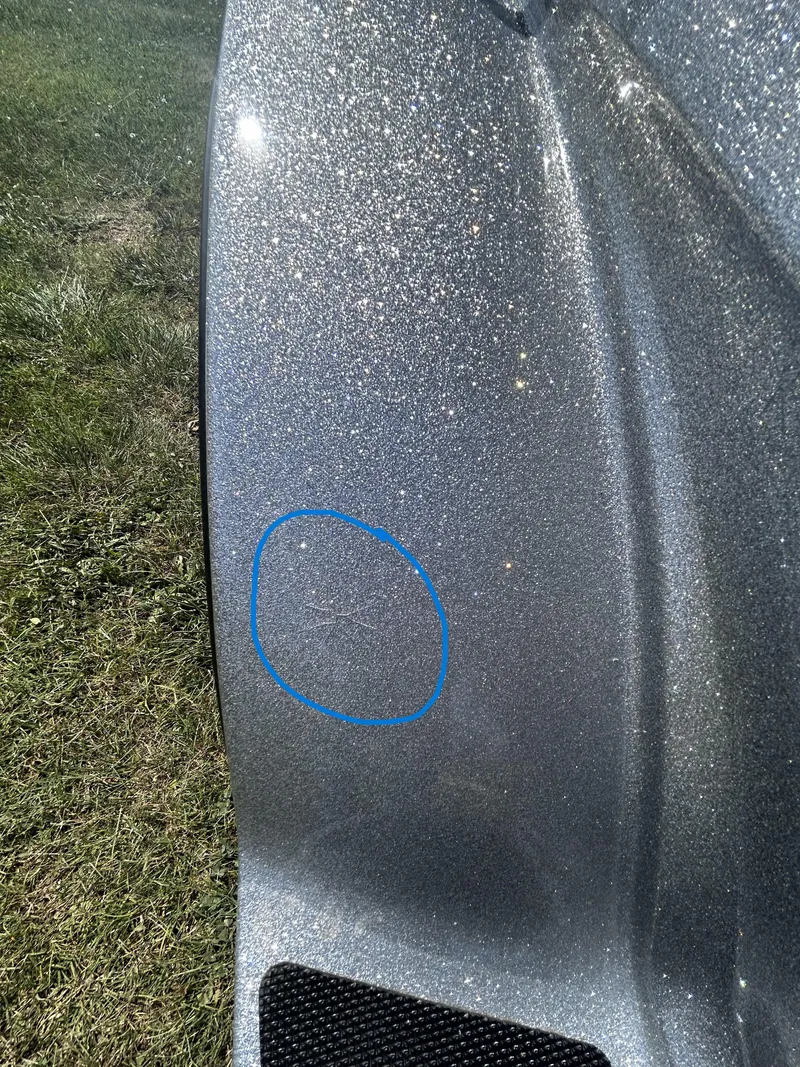 Slide: The Image of 2024 Triton 21XP boat with a scratch circled in blue on metallic surface. - 11