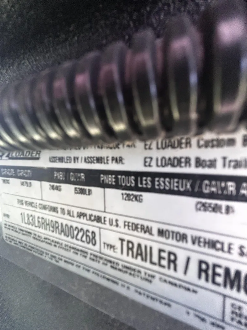Slide: The Image of Close-up of a 2024 Triton 21XP trailer label with specifications and compliance details. - 15
