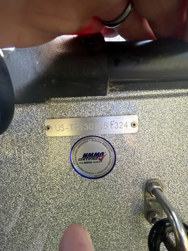 Slide: The Image of 2024 Triton 21XP boat hull identification number and NMMA certification sticker. - 16