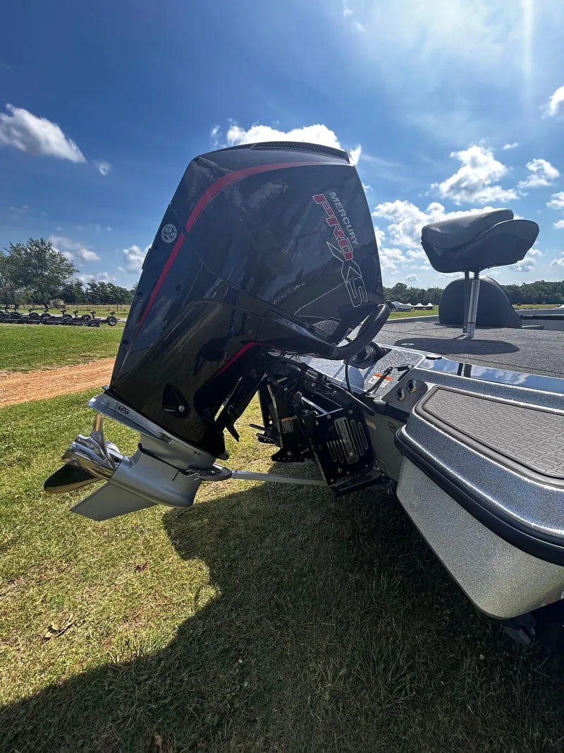 Slide: The Image of 2024 Triton 21XP boat with Mercury Pro XS outboard motor on grassy field. - 17