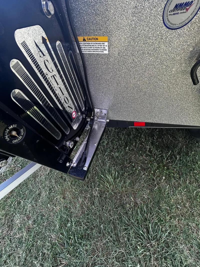 Slide: The Image of 2024 Triton 21XP boat detail, showing metallic finish and caution label on grass. - 19