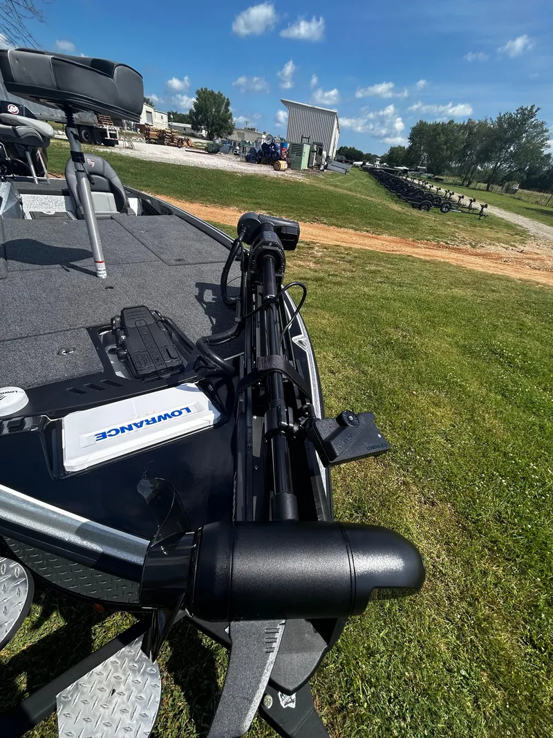 Slide: The Image of 2024 Triton 21XP boat with Lowrance equipment on grassy area under blue sky. - 24
