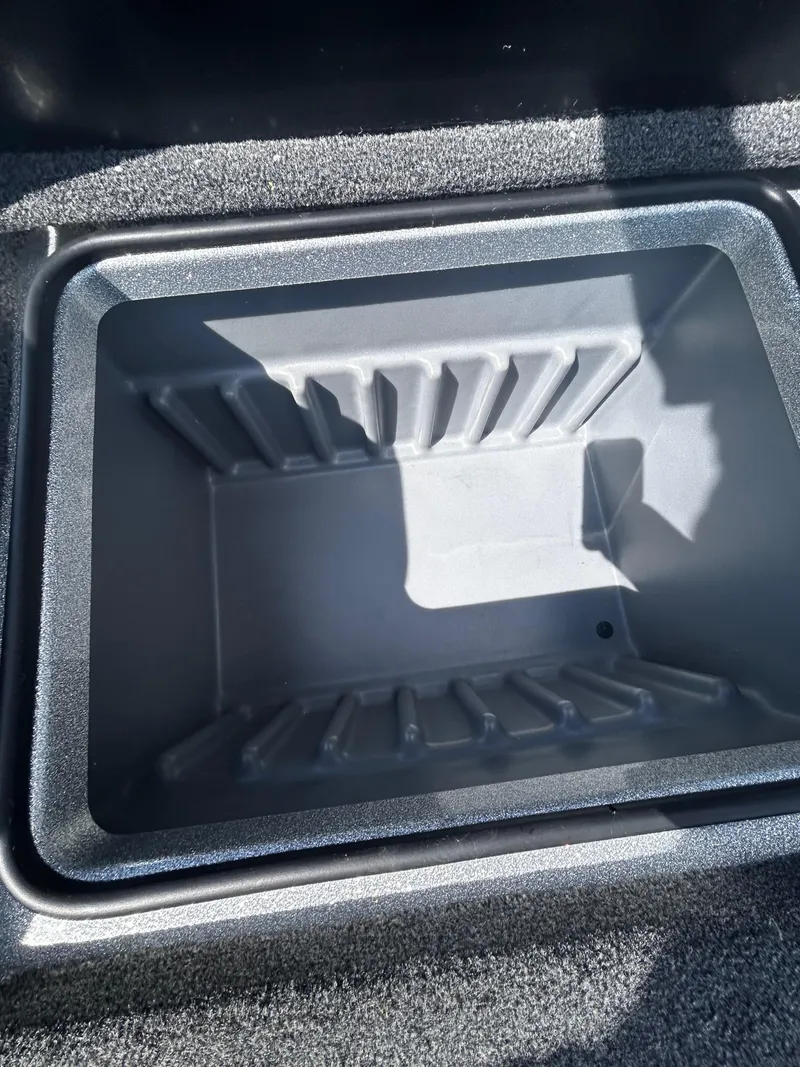 Slide: The Image of 2024 Triton 21XP boat storage compartment, empty and open, with textured interior. - 30