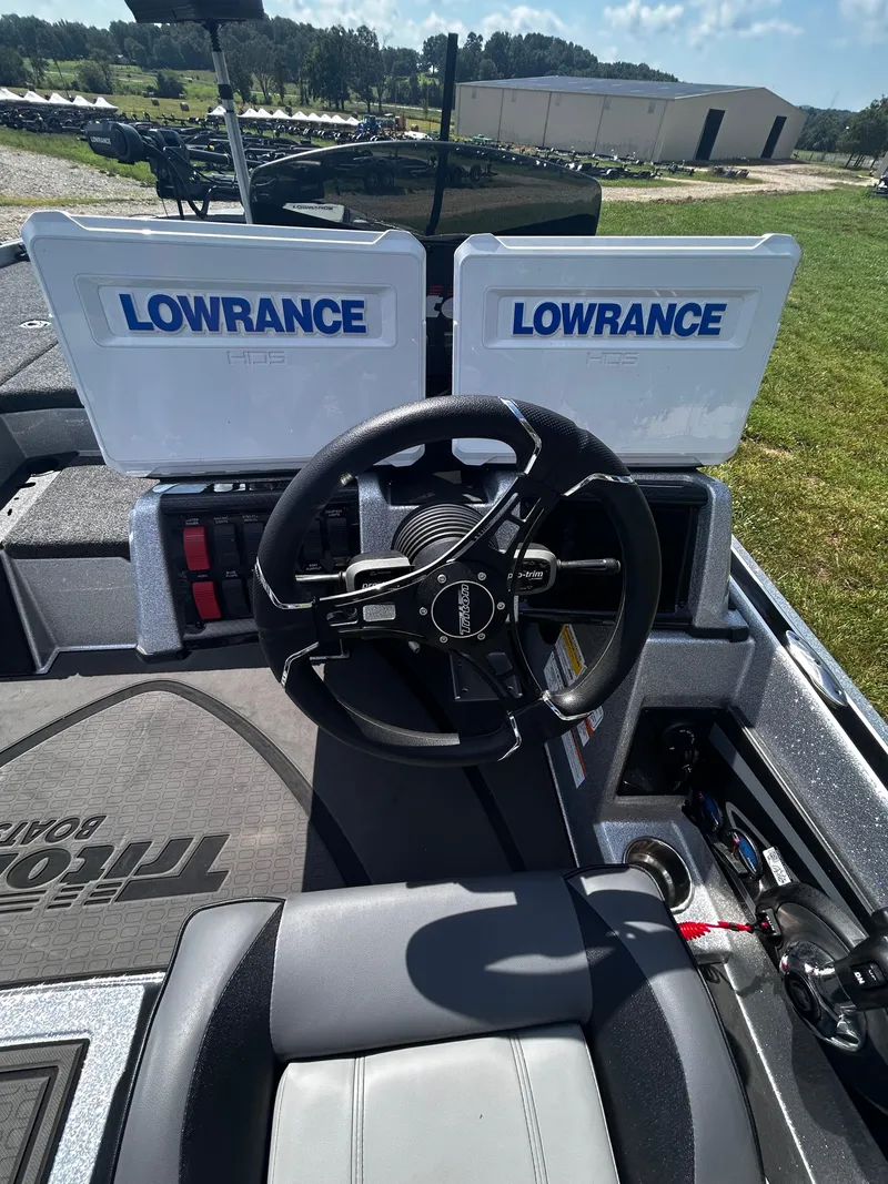 Slide: The Image of 2024 Triton 21XP boat dashboard with dual Lowrance displays and steering wheel. - 32