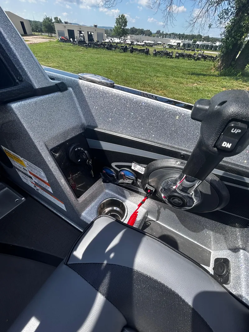 Slide: The Image of Interior of 2024 Triton 21XP boat showing control panel and throttle lever. - 33