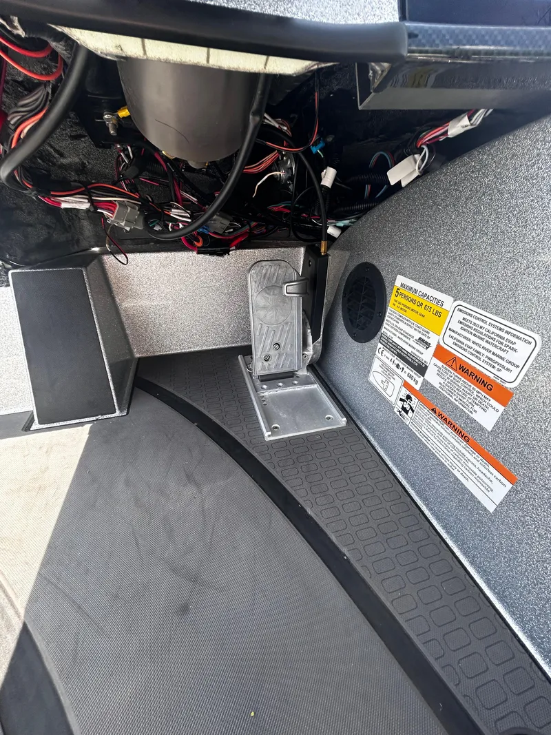 Slide: The Image of Interior view of 2024 Triton 21XP boat showing wiring and foot pedal. - 34
