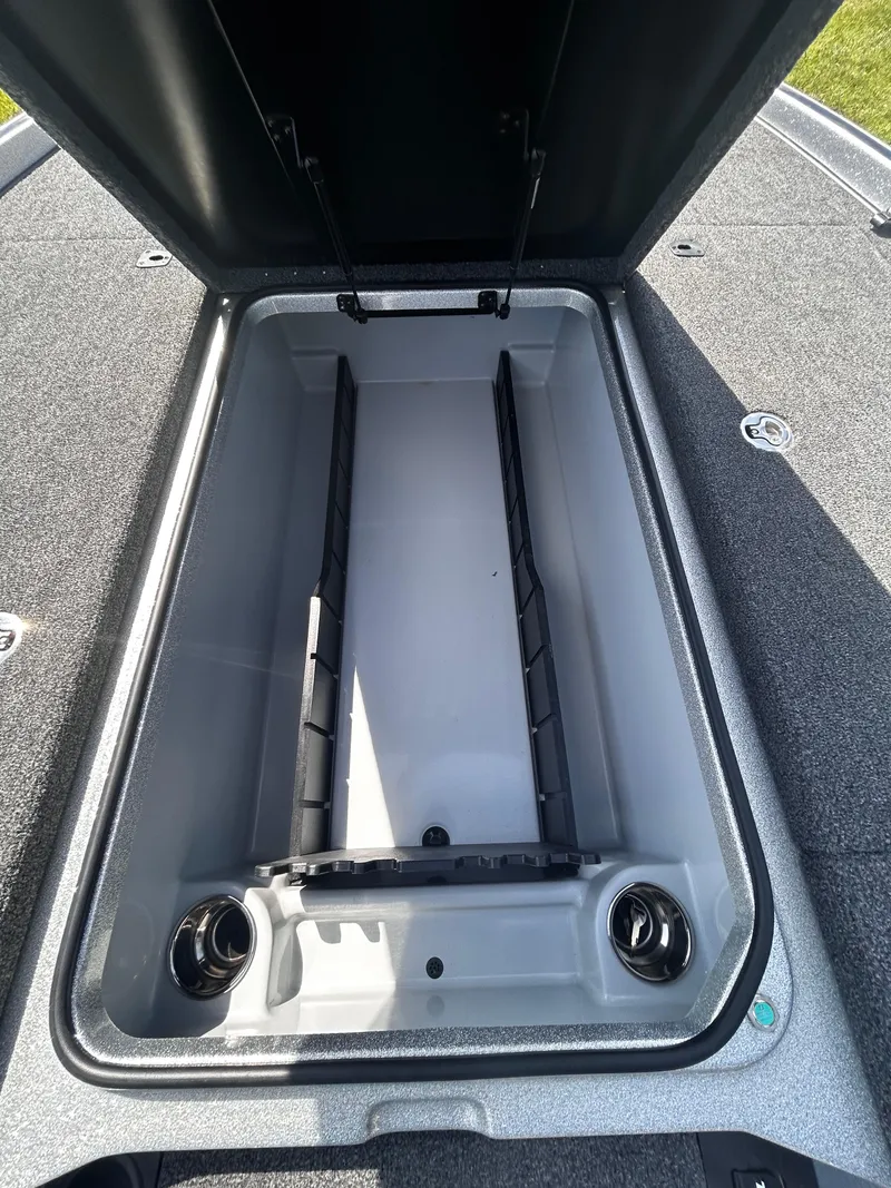 Slide: The Image of Open storage compartment in 2024 Triton 21XP boat, featuring spacious interior and secure lid. - 4
