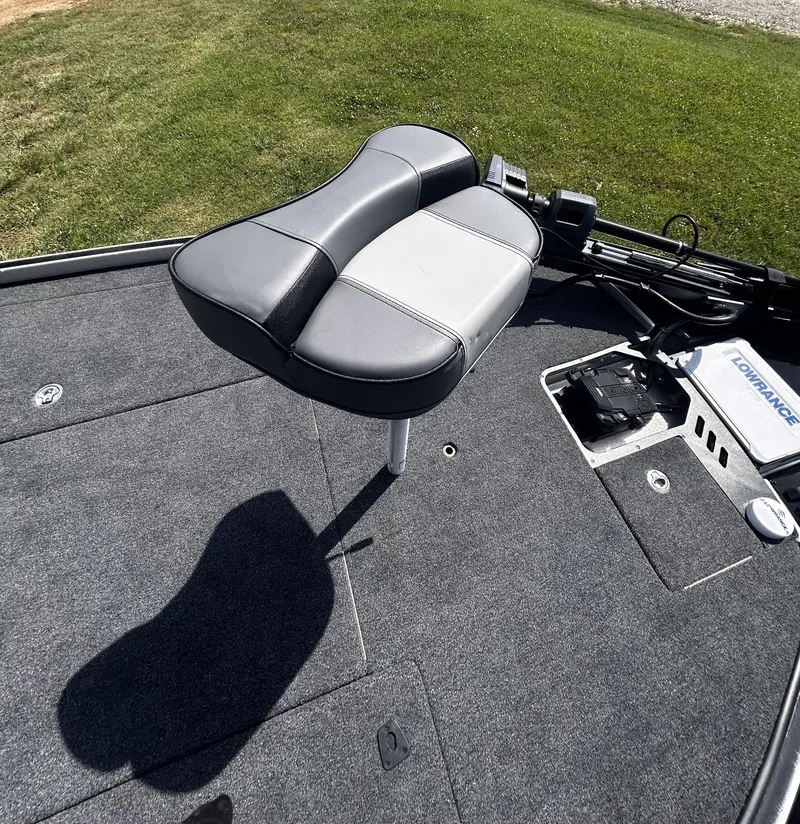 Slide: The Image of 2024 Triton 21XP boat seat and deck with fishing equipment. - 8