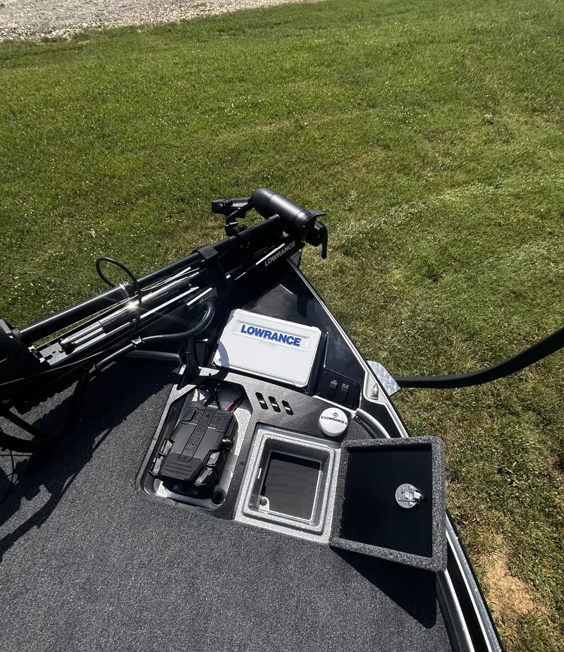 Slide: The Image of 2024 Triton 21XP boat deck with Lowrance electronics and trolling motor on grass. - 9