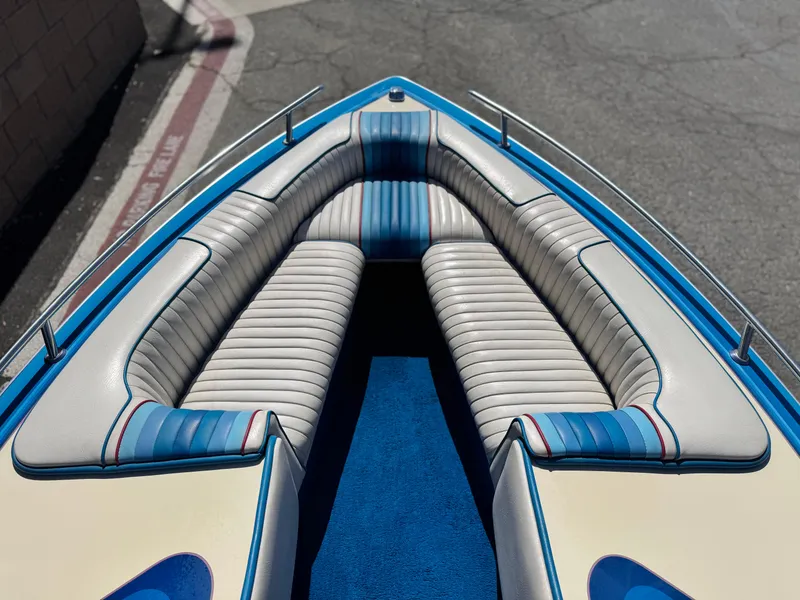 Slide: The Image of 1987 Bahner 19 BR boat interior with blue and white seating, viewed from above. - 10