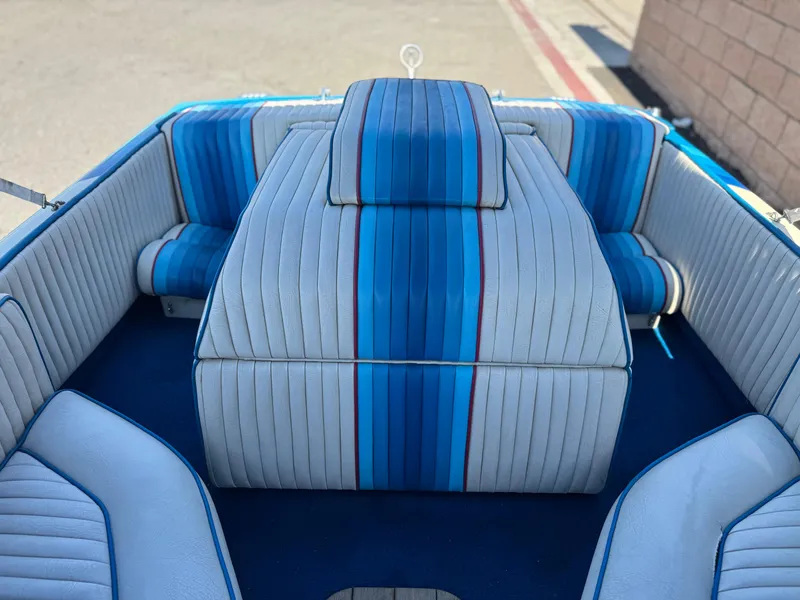 Slide: The Image of 1987 Bahner 19 BR boat interior with blue and white striped upholstery. - 12