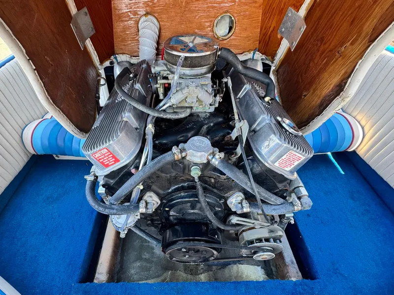 Slide: The Image of Engine of a 1987 Bahner 19 BR boat, showcasing detailed components and blue interior. - 13