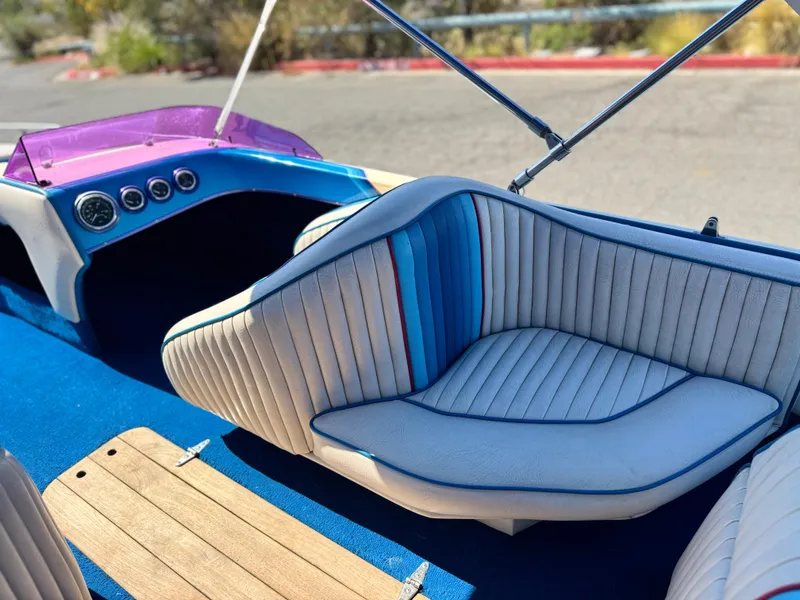 Slide: The Image of Interior of a 1987 Bahner 19 BR boat with blue and white seating. - 14