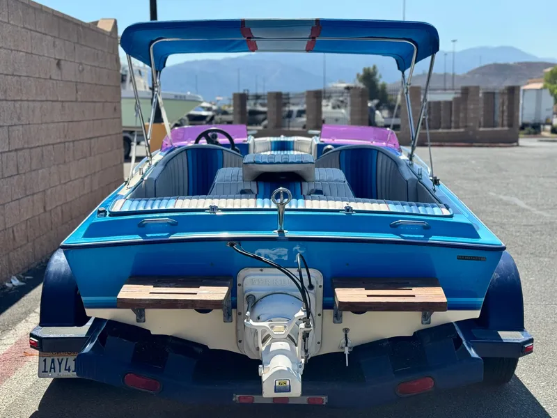 Slide: The Image of 1987 Bahner 19 BR boat with blue and white interior, parked outdoors. - 4