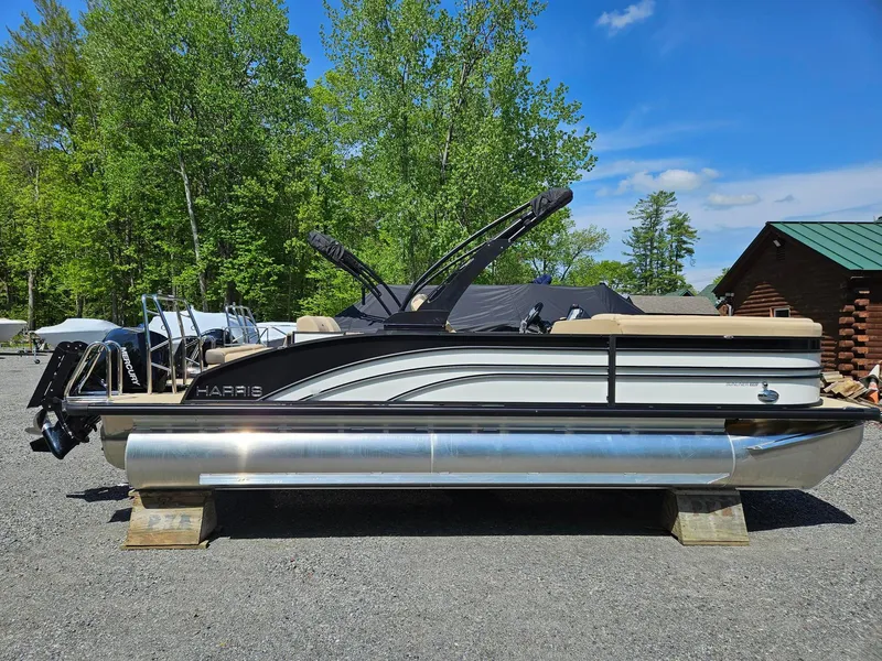 The Image of 2025 Harris Sunliner 230 pontoon boat on display outdoors. - 0