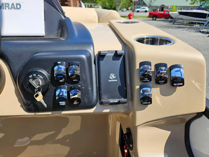 Slide: The Image of Control panel of 2025 Harris Sunliner 230 boat with switches and key ignition. - 11